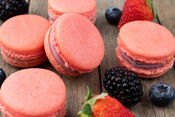 Berry macarons over wooden table