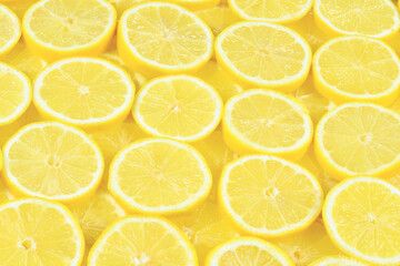 A slices of fresh juicy yellow lemons.  Texture background, pattern.