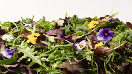 Fresh mix of salads with edible flowers. Top view.