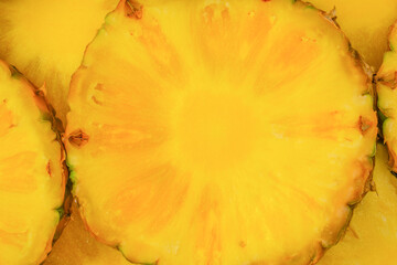 Pineapple juicy yellow slices as a background.