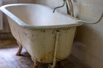 old dirty bathtub in a house