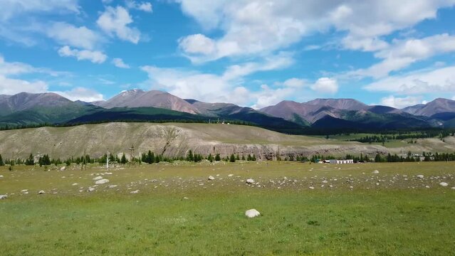 View from the car window to the mountains, Tunkinskaya valley, Siberia. Gimbal shot.