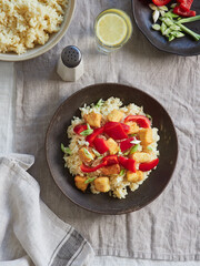 view from above dish on the table with rice, red bell pepper, spring onion and chicken