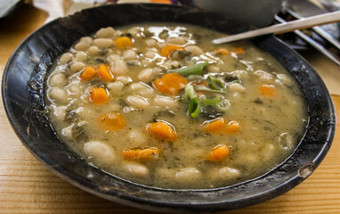 Traditional greek soup with white beans and carrots at Crete, Greece