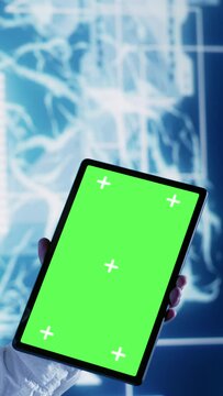 Vertical video Skillful IT consultant using green screen tablet to implement artificial intelligence parallel processing. Dilligent supervisor oversees chroma key device enabling AI to do machine