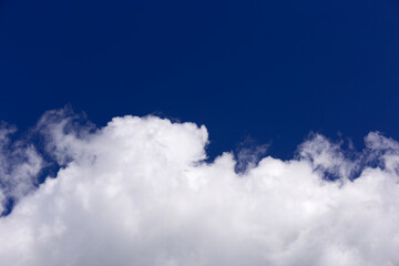 White clouds on blue sky background.