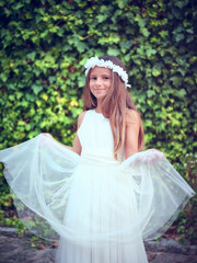 Fototapeta premium Happy girl in white dress smiling in summer park