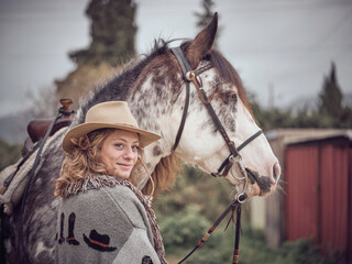 Smiling female equestrian and horse