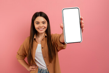 Look At This. Smiling Teen Girl Showing Mobile Phone With Blank Screen