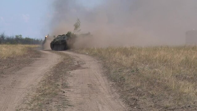tanks and armored personnel carriers moving around the range at military exercises