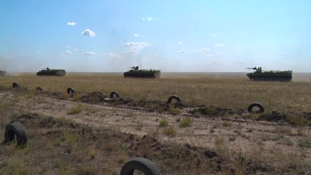 armored personnel carriers moving around the range at military exercises
