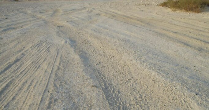 Tire tracks in sand in the desert area close to oil field in Riffa