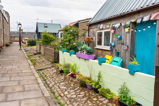 Fishermen's houses with brightly coloured plants and decorations in the Footdee Sweep, Aberdeen, Scotland.