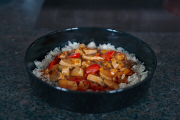 ready to eat - sliced and grilled chicken in a curry sauce with rice 
