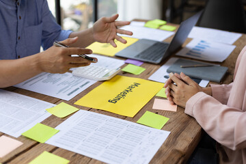 Meeting of colleagues is discussing financial statement analysis in accounting and brainstorming business strategy plans.