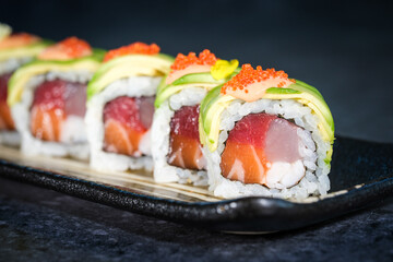 Delicious sushi rolls with avocado slices