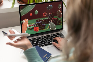 Online gambling, betting concept. Poker chips, casino roulette on laptop and phone screens. Man...