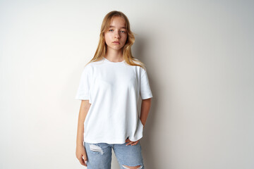 Obraz premium Portrait of young beautiful cute teen girl posing at camera