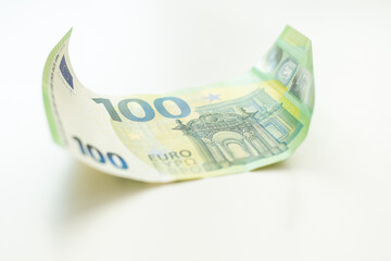 Fragment part of 100 euro banknote close-up with small brown details. (European Union currency).