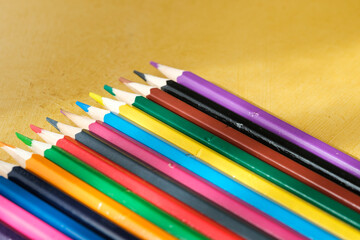 Coloured pencils for drawing on a yellow background