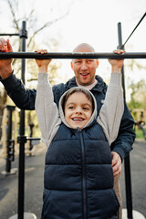 Fototapeta premium Happy father with his son spending time together on a sports ground