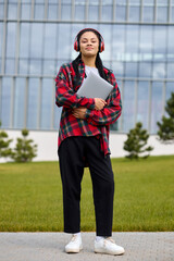 African-American student embraces the knowledge hub of a university, laptop aiding her educational.