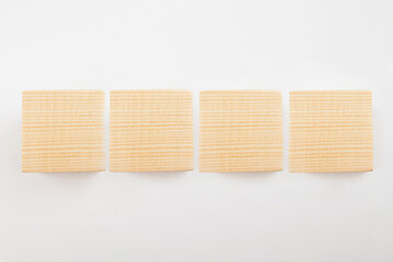 Four empty wooden cubes on a white background.