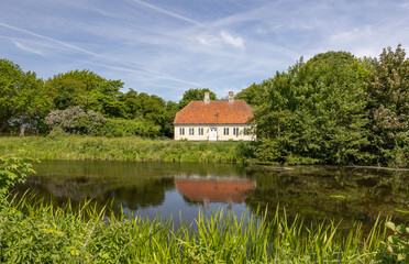 Fototapeta na wymiar Old house on the lake,Tranekjær,Langeland,Denmark