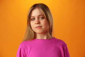 Fototapeta premium Upset disturbed teen girl on yellow background