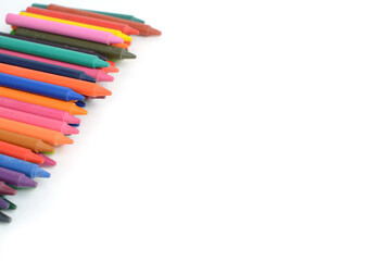 Crayons lined up isolated on white background.