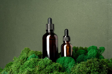 Vape smoking liquid bottles on moss background