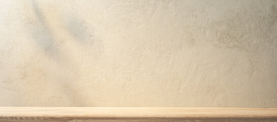 Sand-colored rough stone wall and wooden shelf in front of it. Kitchen texture background