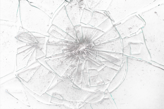 Broken glass on black background with lots of glass splinters and cracks