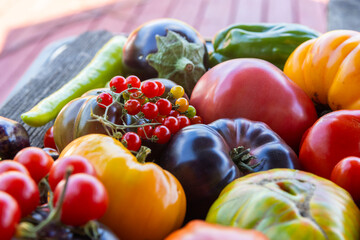 Colourful heirloom tomatoes on grey rustic background