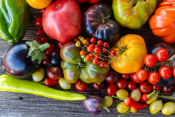 Colourful heirloom tomatoes on grey rustic background