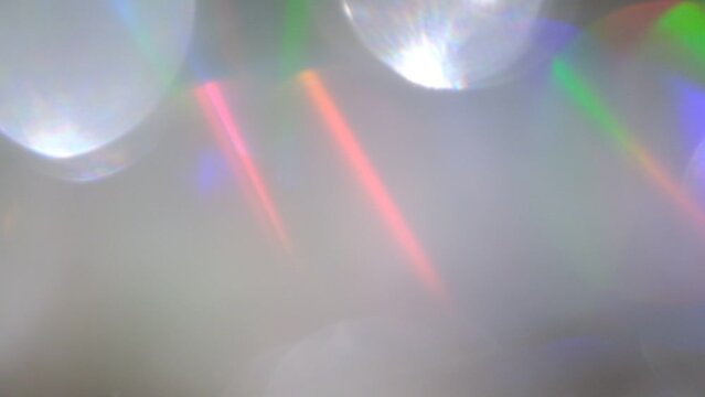 Multicolored Glittering abstract flares bokeh background. Blurry abstract fairy light background with bokeh. Caustic light, refraction. La