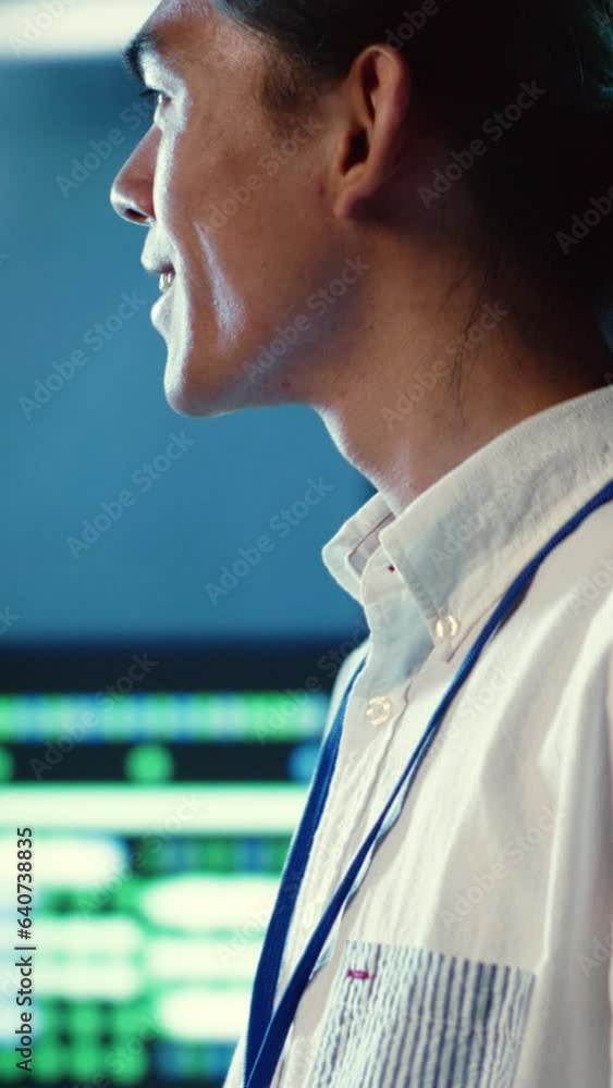 Poster vertical video seasoned employee walking through data center machines providing processing resources