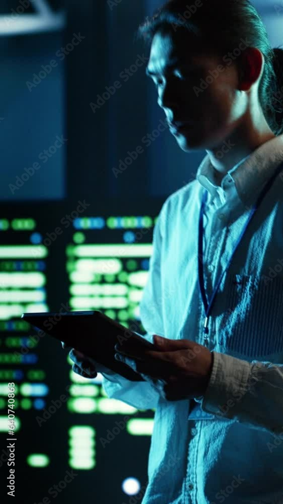 Poster vertical video asian man strolling through data center server rows providing processing and memory r