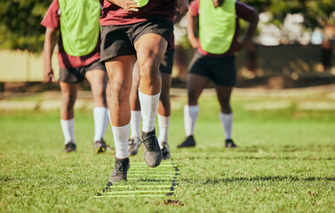 Fototapeta premium Sports, running and men for rugby training, workout and exercise on grass field for competition. Fitness, teamwork and feet of athletes with equipment outdoors for match practice, challenge and game
