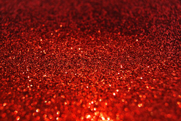 Red de focused sparkle glitter background close up