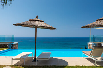 Luxury villa with infinity pool over the sea.