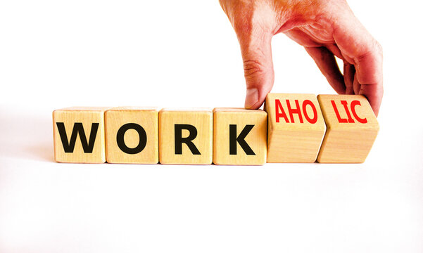 Work or workaholic symbol. Concept words Work or Workaholic on wooden cubes. Beautiful white table white background. Businessman hand. Business work or workaholic concept. Copy space.
