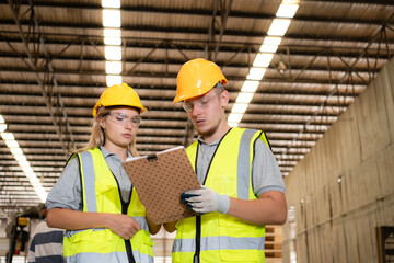 Both of workers work in a woodworking factory, Checking inventory the wood in the wooden warehouse
