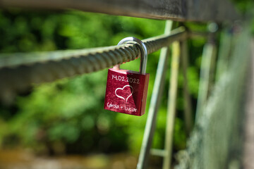 padlock as a symbol of a couple's love hanging from a bridge