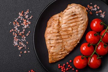 Delicious juicy grilled chicken fillet with salt, spices and herbs