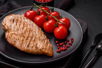 Delicious juicy grilled chicken fillet with salt, spices and herbs