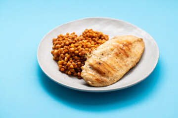 Bowl of boiled red lentils and chicken breast in a ceramic bowl