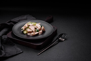 Delicious juicy fresh salad of cucumbers and grilled chicken slices, with french mustard