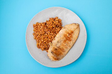 Bowl of boiled red lentils and chicken breast in a ceramic bowl