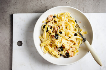 Tagliatelle pasta with tuna, olives and cheese.